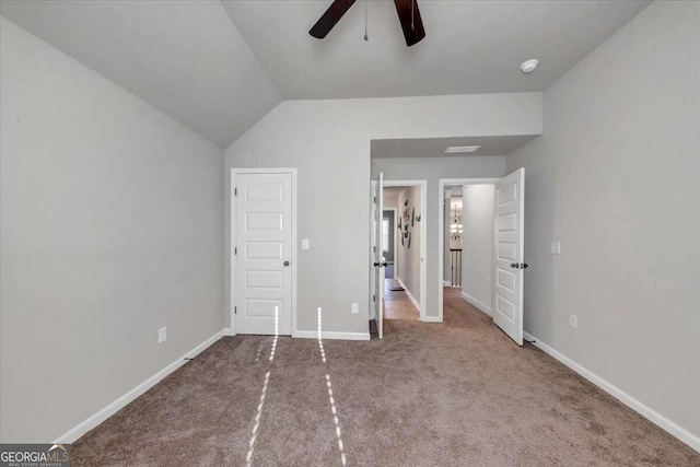 unfurnished bedroom with baseboards, ceiling fan, carpet floors, and vaulted ceiling