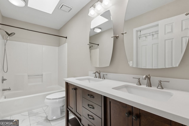 full bathroom with toilet, marble finish floor, a sink, and shower / tub combination