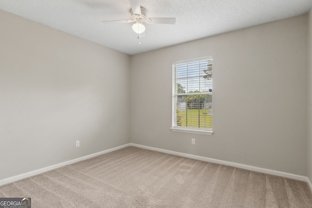 spare room with baseboards, ceiling fan, and carpet floors