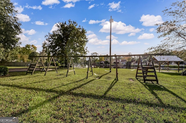 view of jungle gym with a lawn and fence