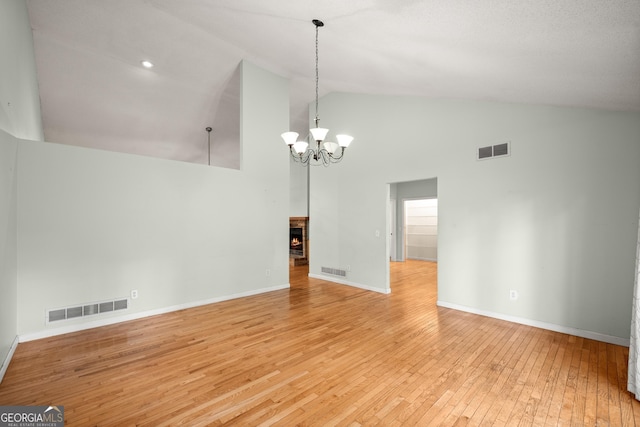 3592 Lakeview Dr, Gainesville, GA 30501 - unfurnished dining area featuring light wood finished floors, visible vents, a chandelier, and high vaulted ceiling