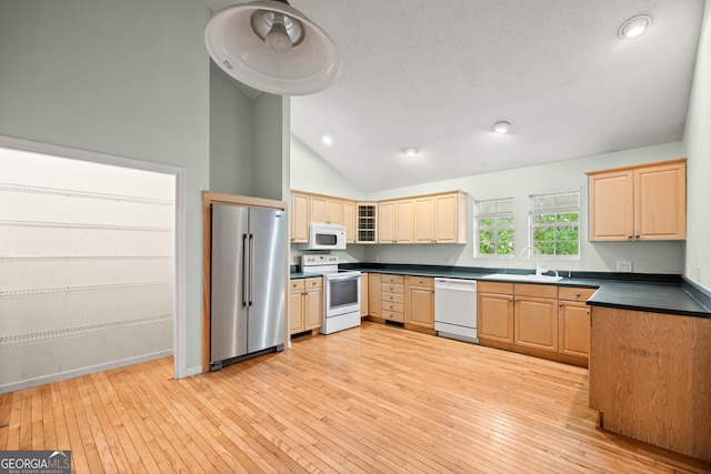3592 Lakeview Dr, Gainesville, GA 30501 - kitchen with light wood finished floors, a sink, white appliances, dark countertops, and lofted ceiling
