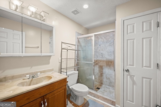 3592 Lakeview Dr, Gainesville, GA 30501 - bathroom featuring vanity, toilet, a stall shower, visible vents, and a textured ceiling