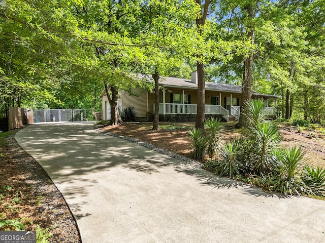 3592 Lakeview Dr, Gainesville, GA 30501 - view of front facade featuring a chimney, covered porch, fence, concrete driveway, and an attached garage
