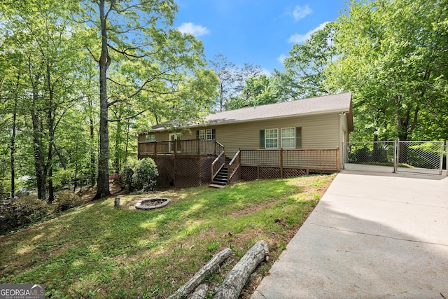 3592 Lakeview Dr, Gainesville, GA 30501 - rear view of property with driveway, a fire pit, a deck, and a yard