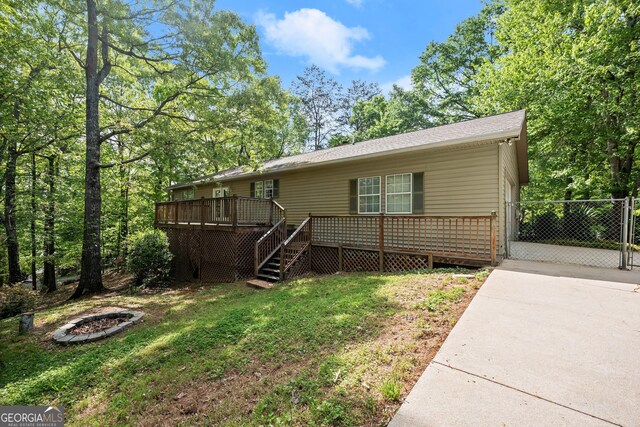 3592 Lakeview Dr, Gainesville, GA 30501 - view of front of home with driveway, a fire pit, a wooden deck, a front yard, and stairway