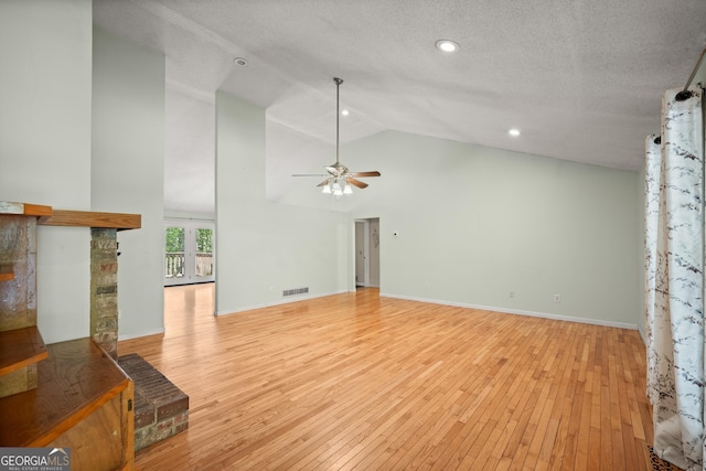 3592 Lakeview Dr, Gainesville, GA 30501 - unfurnished living room with light wood finished floors, a ceiling fan, visible vents, and high vaulted ceiling