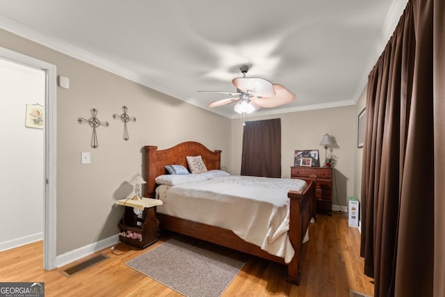 5855 Willis Ln, Cumming, GA 30040 - bedroom with ceiling fan, light wood finished floors, baseboards, visible vents, and crown molding