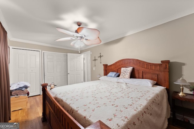 5855 Willis Ln, Cumming, GA 30040 - bedroom with crown molding, ceiling fan, multiple closets, and wood finished floors