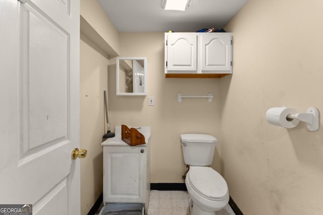5855 Willis Ln, Cumming, GA 30040 - half bathroom featuring vanity, toilet, and baseboards