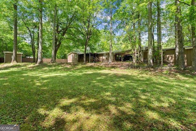 5855 Willis Ln, Cumming, GA 30040 - view of yard featuring fence, a shed, and an outbuilding