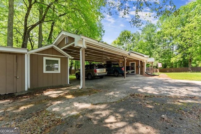 5855 Willis Ln, Cumming, GA 30040 - view of parking / parking lot with concrete driveway, an attached carport, and fence
