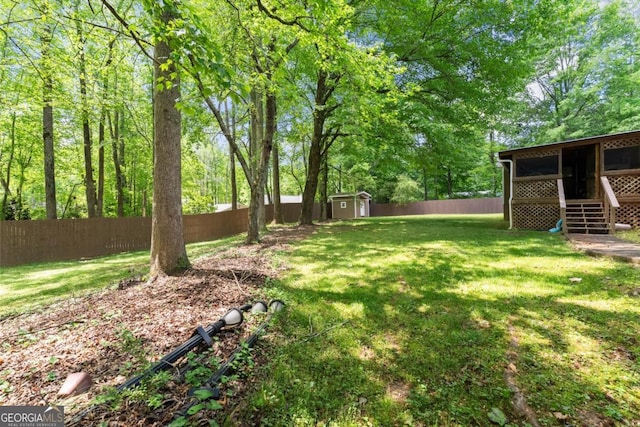 5855 Willis Ln, Cumming, GA 30040 - view of yard featuring a storage shed, a fenced backyard, and an outdoor structure