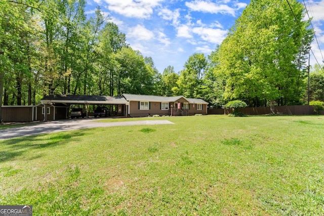 5855 Willis Ln, Cumming, GA 30040 - view of yard featuring a carport, aphalt driveway, and fence