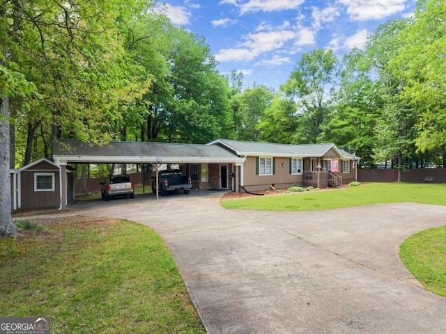 5855 Willis Ln, Cumming, GA 30040 - single story home with a storage unit, fence, a carport, driveway, and a front lawn