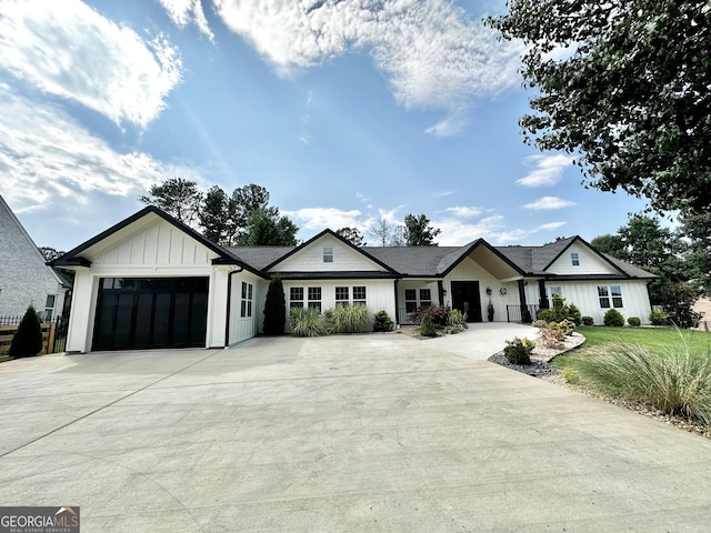 modern farmhouse featuring driveway, board and batten siding, and a garage