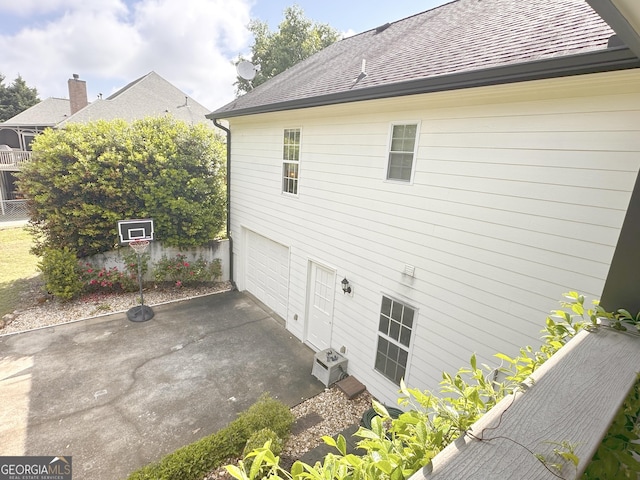 3550 N Bogan Rd, Buford, GA 30519 - view of property exterior with a garage, driveway, and roof with shingles