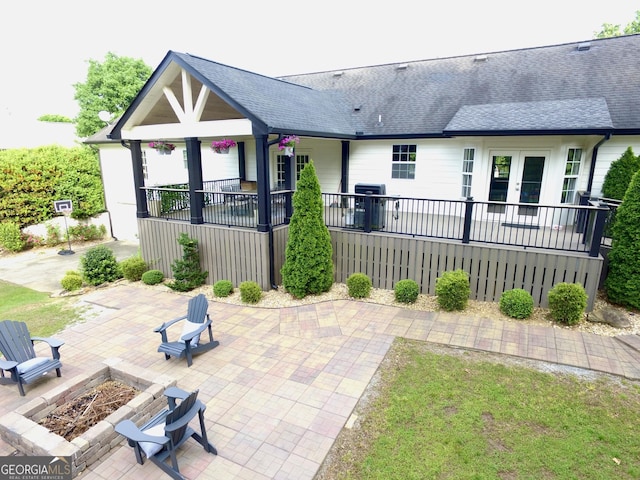 3550 N Bogan Rd, Buford, GA 30519 - rear view of property featuring a fire pit, french doors, a patio, and a shingled roof