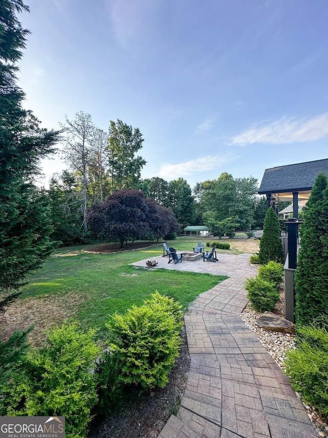 3550 N Bogan Rd, Buford, GA 30519 - view of grassy yard featuring a fire pit and a patio