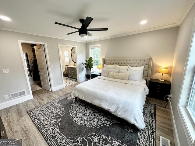 3550 N Bogan Rd, Buford, GA 30519 - bedroom featuring wood finished floors, ornamental molding, baseboards, connected bathroom, and a ceiling fan