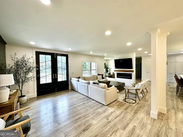 3550 N Bogan Rd, Buford, GA 30519 - living room with french doors, recessed lighting, light wood-style floors, baseboards, and ornamental molding