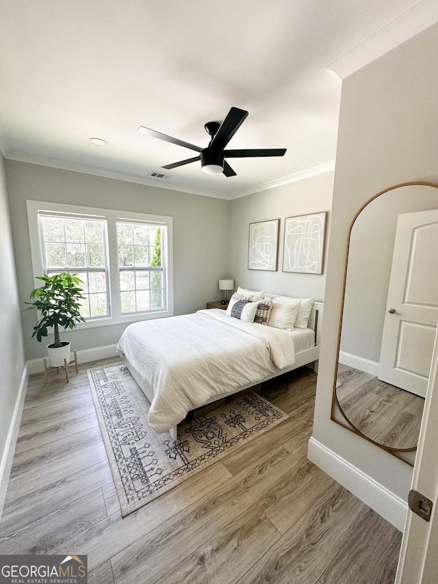 3550 N Bogan Rd, Buford, GA 30519 - bedroom with crown molding, baseboards, wood finished floors, and ceiling fan