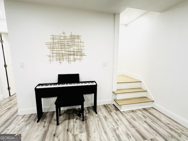 3550 N Bogan Rd, Buford, GA 30519 - sitting room with wood finished floors, baseboards, and stairs