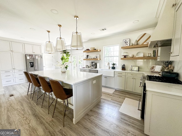 3550 N Bogan Rd, Buford, GA 30519 - kitchen featuring open shelves, stainless steel appliances, a sink, custom range hood, and a center island