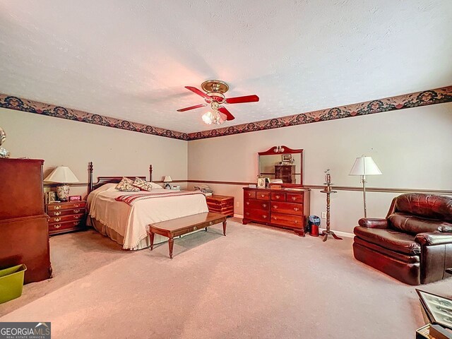 carpeted bedroom with baseboards, a textured ceiling, and ceiling fan