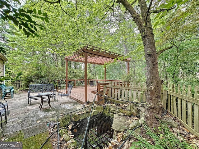 wooden terrace featuring a pergola, fence, and a patio area