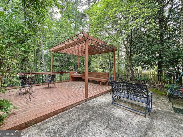 wooden terrace featuring a pergola and fence