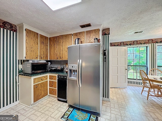 kitchen with dark countertops, stainless steel fridge with ice dispenser, brown cabinetry, and brick patterned floor