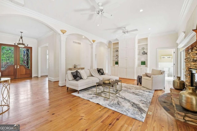 145 Havenbrooke Ct, Fayetteville, GA 30214 - living room featuring arched walkways, ceiling fan, a fireplace, ornate columns, and french doors