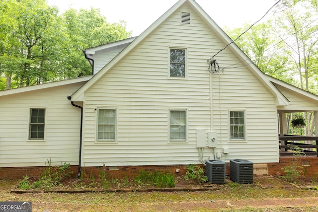 rear view of house featuring crawl space and central AC