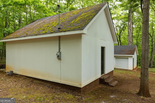 view of outbuilding with an outdoor structure, entry steps, and a garage