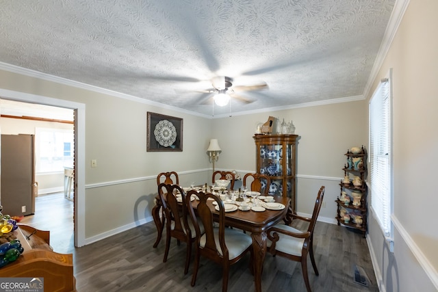 dining area with a ceiling fan, a textured ceiling, visible vents, and dark wood-style floors