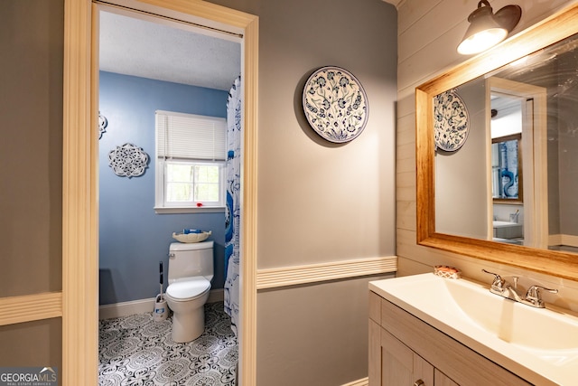 full bath featuring toilet, tile patterned flooring, and vanity