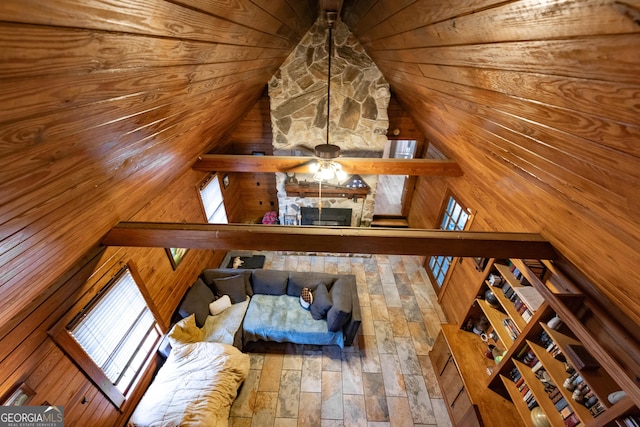 interior space with wood walls, vaulted ceiling, and wooden ceiling