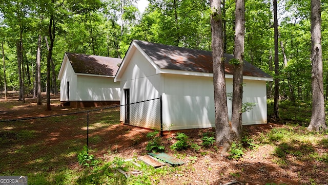 view of outbuilding with fence and an outdoor structure