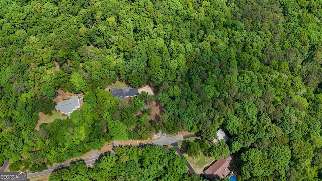 drone / aerial view featuring a view of trees