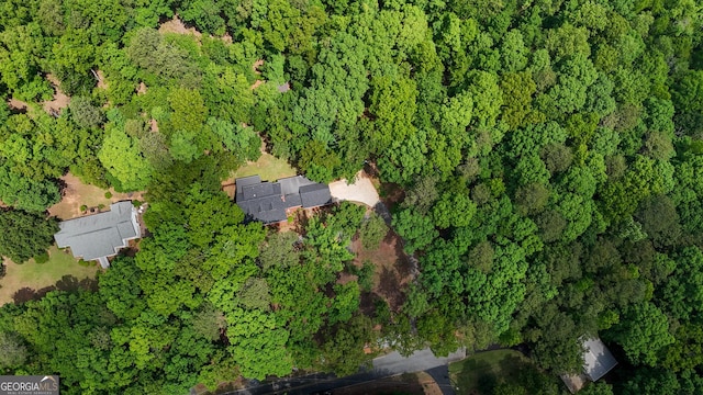 drone / aerial view featuring a view of trees