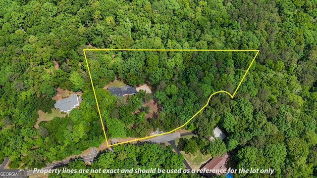 drone / aerial view featuring a forest view