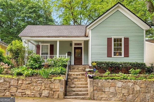 view of front of house with a porch and a shingled roof