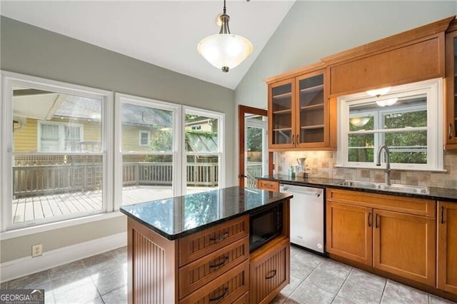 kitchen with black microwave, brown cabinets, dishwasher, a sink, and lofted ceiling