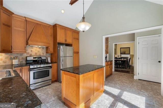 kitchen with appliances with stainless steel finishes, premium range hood, backsplash, and high vaulted ceiling