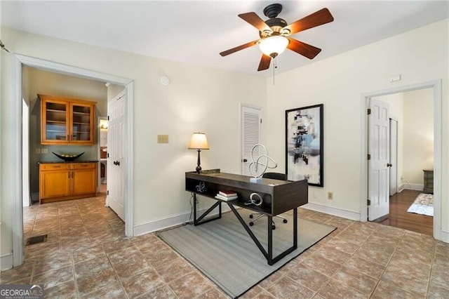 office featuring a ceiling fan, baseboards, and visible vents