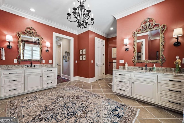 bathroom featuring crown molding, a sink, two vanities, and an inviting chandelier