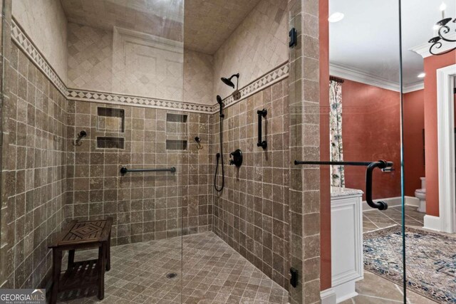 full bath with tile patterned floors, toilet, ornamental molding, and a stall shower