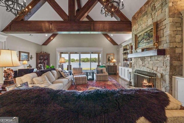 living area with a water view, a fireplace, beam ceiling, high vaulted ceiling, and a notable chandelier