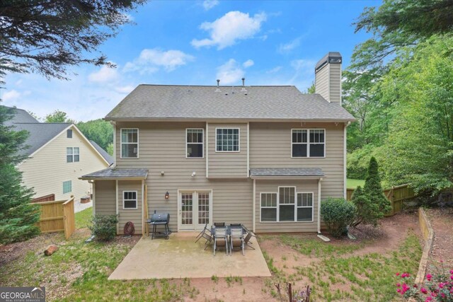 2995 Boulder Walk Ct SE, Atlanta, GA 30316 - back of property with a chimney, a patio, fence, and roof with shingles